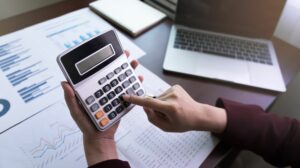 Closeup Business Woman Or Accountant Holding Calculator With Pen