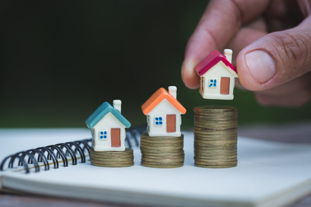 Human Hand Putting House Model On Coins Stack,  Planning Savings